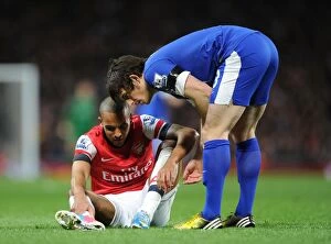 Images Dated 16th April 2013: Theo Walcott and Leighton Baines: A Moment of Respite Amidst the Arsenal v Everton Rivalry