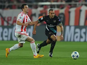 Olympiacos V Arsenal 2015-16 Prints: Theo Walcott Outmaneuvers Lukas Milivojevic: Olympiacos vs