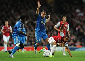 Theo Walcott Outmaneuvers Nicolas N'Koulou and Benoit Cherou as Arsenal Takes on Olympique de Marseille in the UEFA Champions League