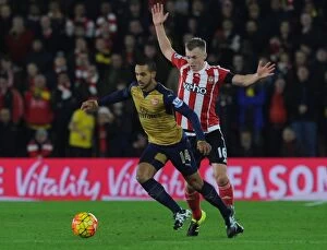 Images Dated 26th December 2015: Theo Walcott Outmaneuvers Ward-Prowse: Southampton vs. Arsenal, Premier League 2015-16