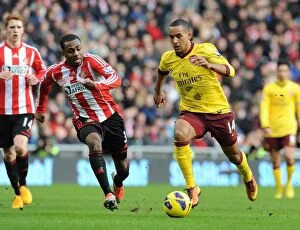 Images Dated 9th February 2013: Theo Walcott Outspeeds Danny Rose in Sunderland vs Arsenal Premier League Clash