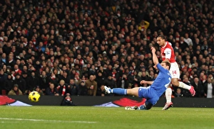 Images Dated 27th December 2010: Theo Walcott scores Arsenals 3rd goal under pressure from Branislav Ivanovic