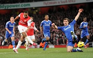 Images Dated 27th December 2010: Theo Walcott scores Arsenals 3rd goal under pressure from Branislav Ivanovic