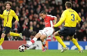 Images Dated 31st March 2010: Theo Walcott shoots past Barcelona goalkeeper Victor Valdes to score the 1st Arsenal goal