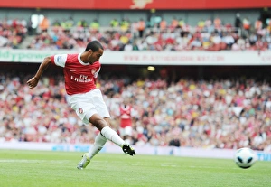 Images Dated 21st August 2010: Theo Walcott shoots past Blackpool goalkeeper Matthew Gilks to score the 1st Arsenal goal