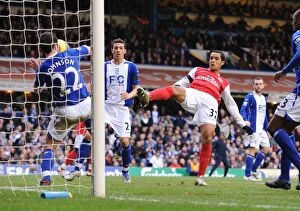 Images Dated 24th February 2008: Theo Walcott shoots past Damien Johnson to score the 1st Arsenal goal
