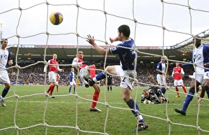 Images Dated 24th February 2008: Theo Walcott shoots past Damien Johnson to score the 1st Arsenal goal