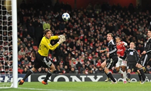 Arsenal v Partizan Belgrade 2010-11 Collection: Theo Walcott shoots past Partizan goalkeeper Vladimir Stojkovic to score the 2nd Arsenal goal