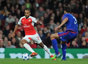 Arsenal V Olympiacos 2015/16 Prints: Theo Walcott vs. Alberto Botia: Intense Clash in Arsenal's 2015/16 Champions League Match