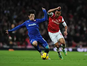 Arsenal V Cardiff City 2013-14 Prints: Theo Walcott vs. Bo-Kyung Kim: Intense Clash at Arsenal vs