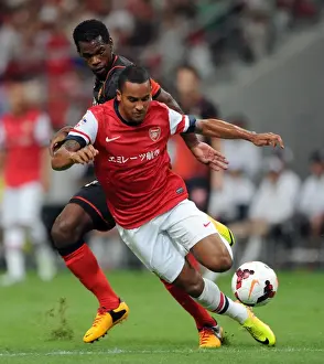 Nagoya Grampus V Arsenal 2013-14 Prints: Theo Walcott vs Danilson: Clash in the 2013-14 Nagoya Grampus vs Arsenal Match