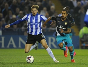 Theo Walcott vs. Glenn Loovens: Intense Clash in Sheffield Wednesday vs. Arsenal Capital One Cup Match