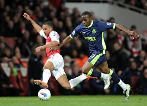 Images Dated 16th April 2012: Theo Walcott vs. Maynor Figueroa: A Fierce Rivalry Unfolds at Emirates Stadium (Arsenal vs)