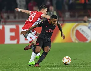 Red Star Belgrade V Arsenal 2017-18 Prints: Theo Walcott vs Milan Rodic: A Battle in the Europa League between Crvena Zvezda and Arsenal FC