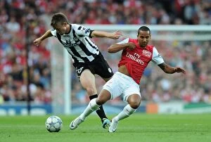 Arsenal v Udinese 2011-12 Collection: Theo Walcott vs Neuton: A Football Battle at the Emirates - Arsenal vs Udinese