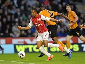 Wolverhampton Wanderers v Arsenal 2011-12 Collection: Theo Walcott vs Sebastien Bassong: A Penalty Showdown at Molineux (2011-12)