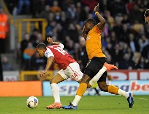 Wolverhampton Wanderers v Arsenal 2011-12 Collection: Theo Walcott vs. Sebastien Bassong: A Penalty Showdown Deciding Arsenal's Victory (2011-12)