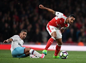 Arsenal v West Ham United 2016-17 Collection: Theo Walcott's Sneaky Move: Outsmarting Manuel Lanzini in the Arsenal vs. West Ham Clash