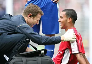 Arsenal V Real Madrid Prints: Theo Walcott's Victory Moment with Arsenal Physio Colin Lewin after Arsenal's 1:0 Win over Real Madrid