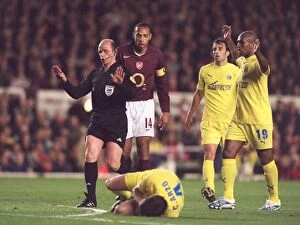 Thierry Henry (Arsenal) looks on as Cesar Arzo (Villarreal) rolls on the floor