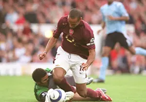 Thierry Henry (Arsenal) is tripped by David James (Man City) for the Arsenal penalty