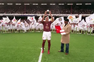Thierry Henry is presented with a golden canon by Ian Wright for becoming Arsenals all time record