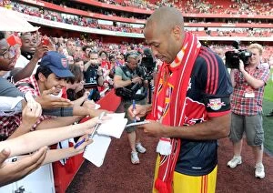 Thierry Henry (Red Bulls) signs autographs for the fans at the end of the match