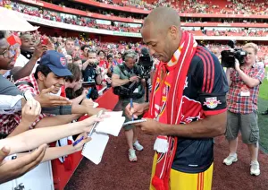 Arsenal V New York Red Bulls 2011-12 Prints: Thierry Henry (Red Bulls) signs autographs for the fans at the end of the match