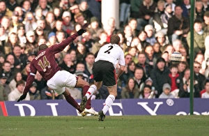 Images Dated 4th March 2006: Thierry Henry scores Arsenals 1st goal under pressure from Moritz Volz (Fulham)