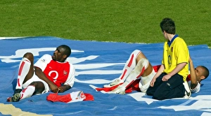 Thierry henry signs a shirt for a fan at the end of the match as Sol Campbell Thierry henry signs a shirt for a fan at the end of the match as Sol Campbell