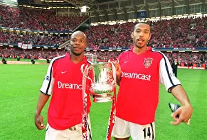 Thierry Henry and Sylvain Wiltord celebrate the Arsenal victory