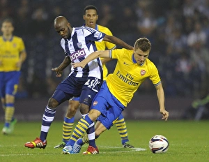 West Bromwich Albion v Arsenal 2013-14 - Capital Cup Collection: Thomas Eisfeld (Arsenal) Youssouf Mulumbu (WBA). West Bromwich Albion 1: 1 Arsenal