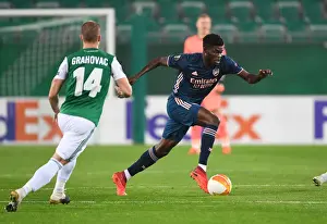 Thomas Partey Breaks Past Rapid Wien's Srdan Grahovac in Arsenal's UEFA Europa League Clash