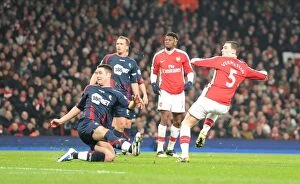 Images Dated 20th January 2010: Thomas Vermaelen shoots past Bolton defender Gary Cahill to score the 3rd Arsenal goal
