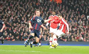 Thomas Vermaelen shoots past Bolton defender Gary Cahill to score the 3rd Arsenal goal