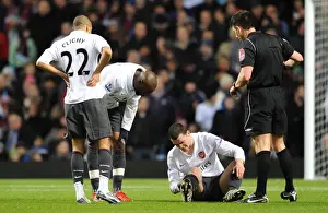Thomas Vermaelen sits injuryed on the pitch as Gael Clichy and William Gallas