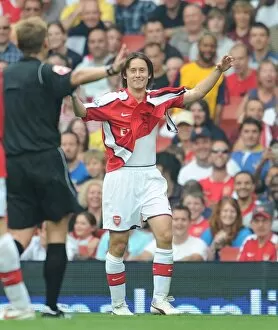 Tomas Rosicky (Arsenal) shows the referee his torn shirt