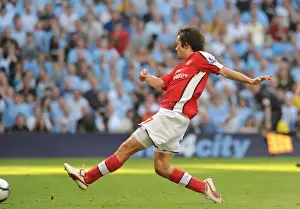 Tomas Rosicky shoots past Man City goalkeeper Shay