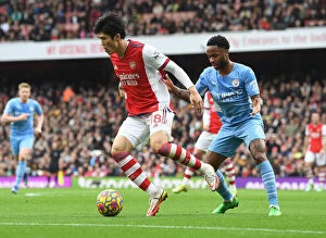 Arsenal v Manchester City 2021-22 Collection: Tomiyasu vs Sterling: A Premier League Showdown at the Emirates