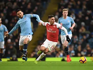 Manchester City V Arsenal 2018-19 Prints: Torreira Stands Firm: A Defiant Tackle Against Manchester City's Silva in the Intense 2018-19 Premier League Clash