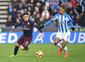 Torreira Tears Through Huddersfield: Arsenal's Lucas Torreira Outmaneuvers Opponent During Premier League Clash