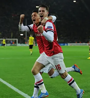 Borussia Dortmund V Arsenal 2013-14 Prints: Unforgettable Goal Celebration: Ramsey and Ozil's Strike for Arsenal at Borussia Dortmund