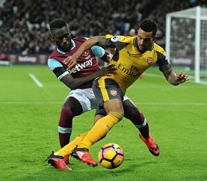 Images Dated 3rd December 2016: Walcott vs. Masuaku: A Football Rivalry Erupts in the West Ham United vs. Arsenal Clash