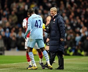 Images Dated 18th December 2011: Wenger and Toure: A Moment of Comradery Amidst Manchester Rivalry (2011-12)