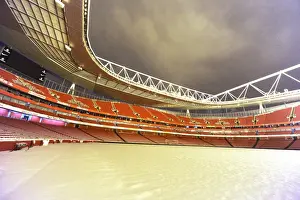 Winter's Grip: Arsenal's Emirates Stadium Blanketed in Snow during Premier League Match