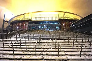 Winter's Grip: Arsenal's Emirates Stadium Blanketed in Snow during Premier League Match