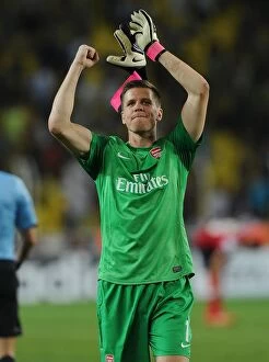 Uefa Champions Laegue Collection: Wojciech Szczesny Celebrates with Arsenal Fans after First Leg of Fenerbahce vs Arsenal