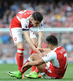 Images Dated 2nd April 2017: Xhaka Consoles Teammate Sanchez Amidst Arsenal-Manchester City Rivalry
