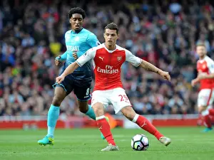 Xhaka Under Pressure: Arsenal's Midfielder Faces Intense Scrutiny from Swansea's Fer in Premier League Showdown