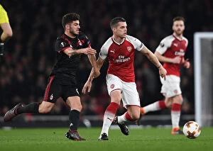 Images Dated 15th March 2018: Xhaka vs. Cutrone: Battle in the Europa League as Arsenal Face Off Against AC Milan